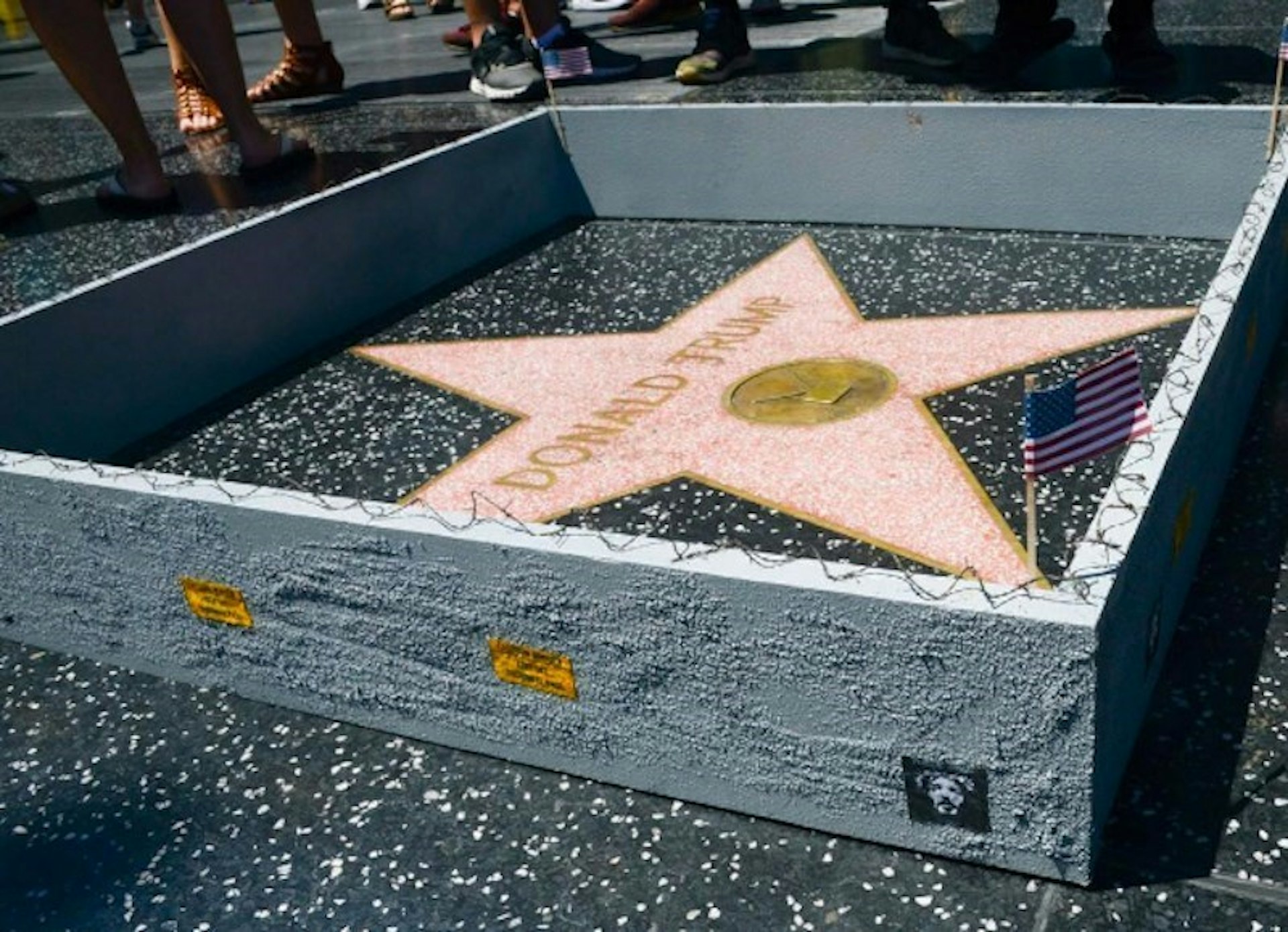 An LA street artist has built a wall around Trump's Hollywood star