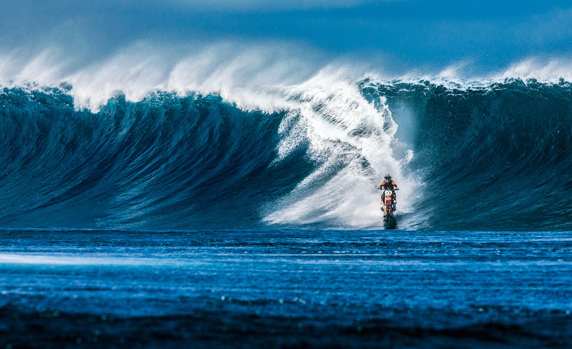 Australian stuntman Robbie Maddison surfs the waves of Tahiti on his dirt bike