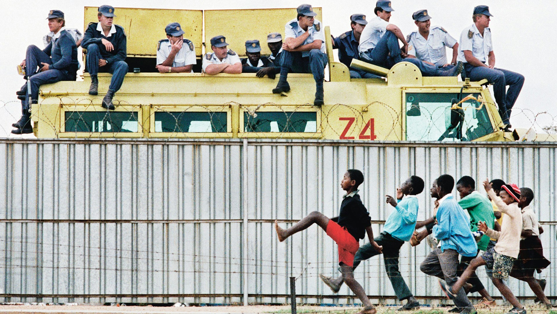 THEN: Youths taunt police during an ANC political rally at the Sam Ntuli Sports Stadium, Thokoza, South Africa, 1991.