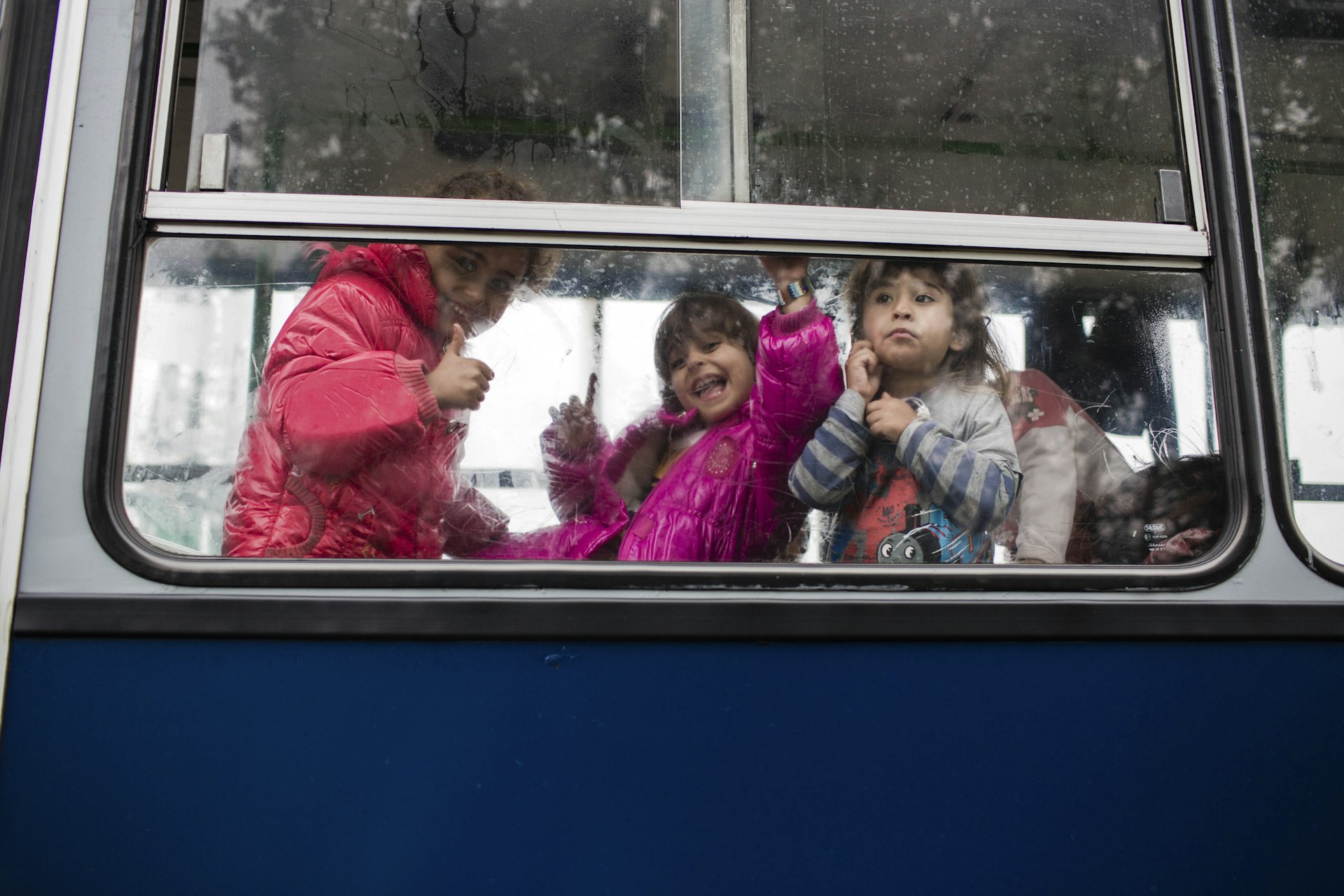 Children waiting on a refugee bus in Hungary.