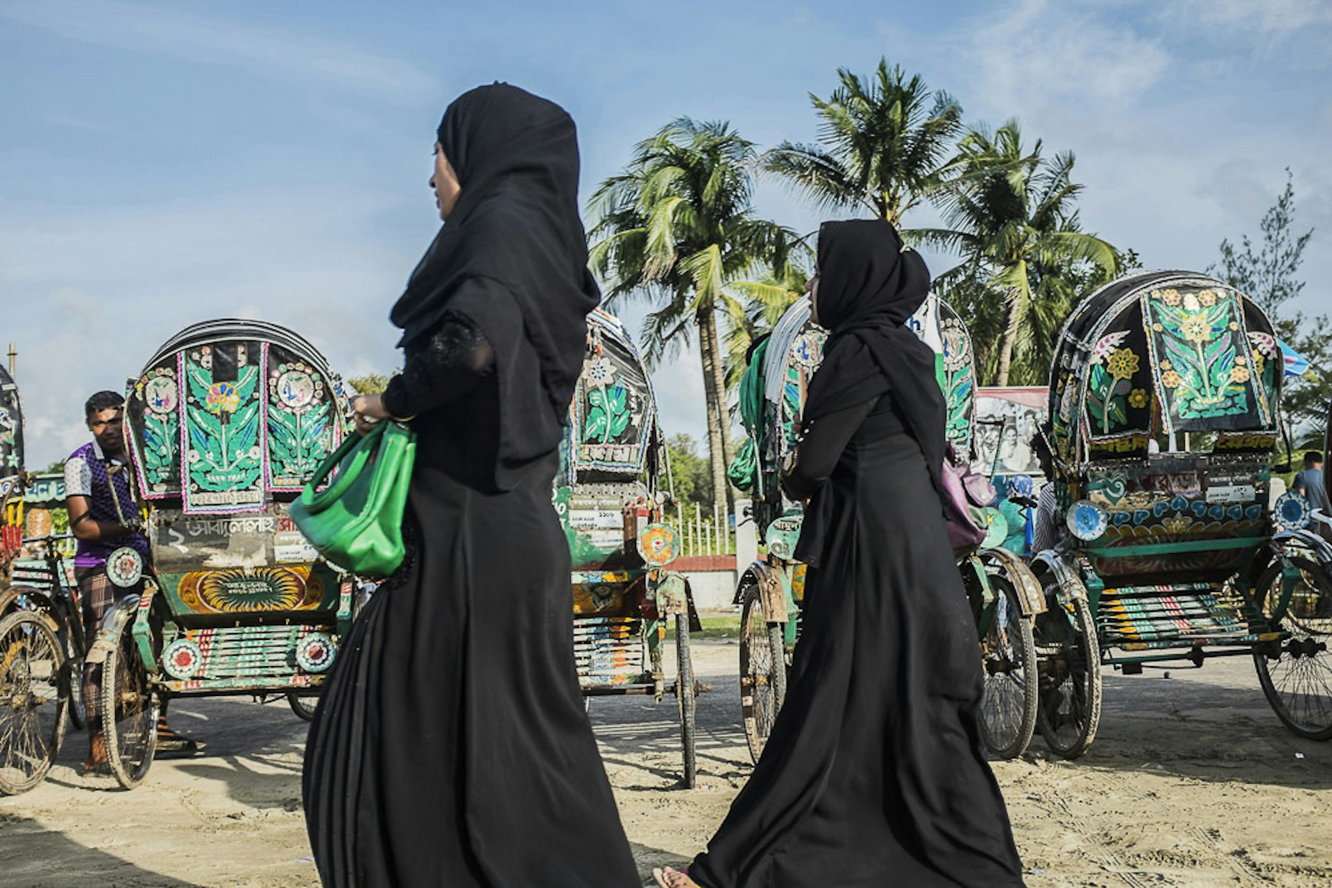 Two young muslim women walk out from the beach of Cox's Bazar, B