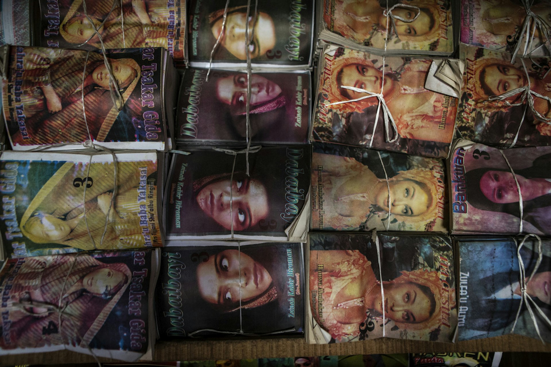 Subversive romance novels are tied up and packaged at the local market in Kano.