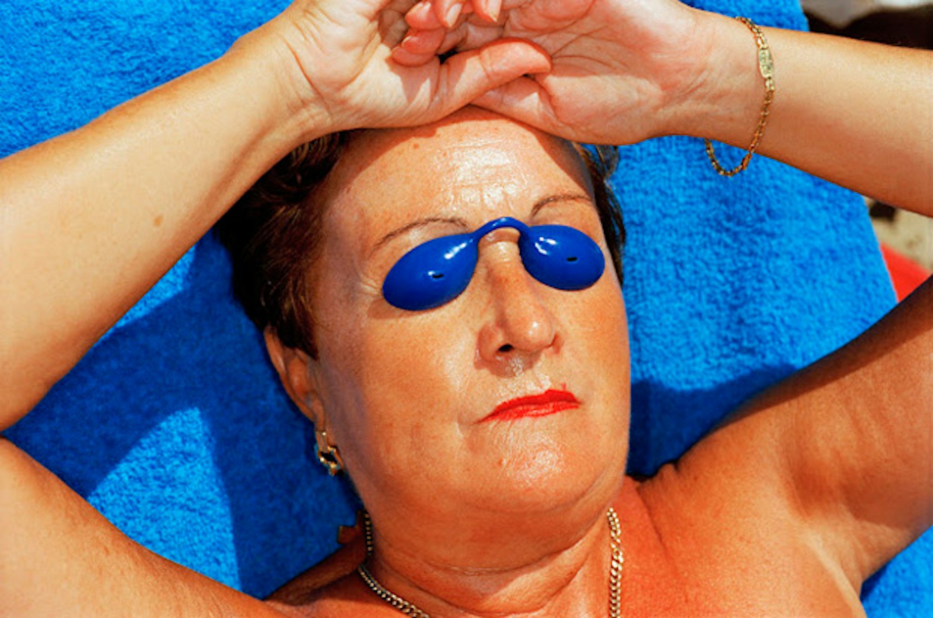 martin-parr-common-sense-woman-sunbathing-spain-1997