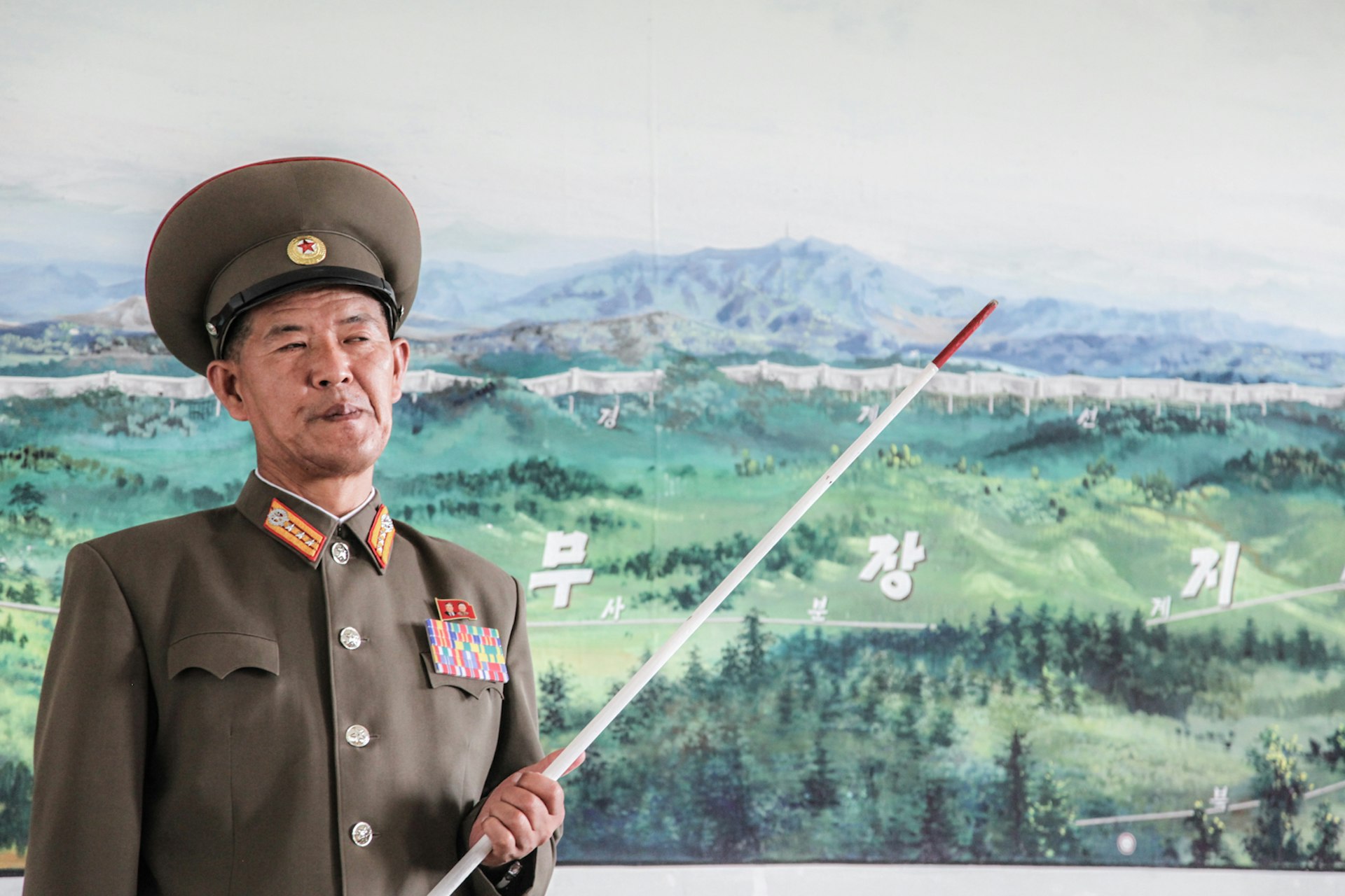 A DPRK officer illustrating a map of the DMZ in Kaesong.
