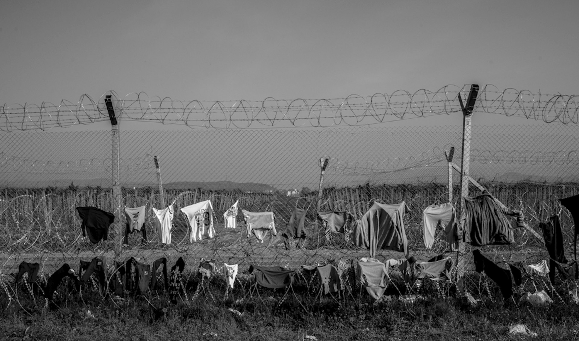 The border fence between Greece and Macedonia from the Greek side in the small village of Idomeni. Migrants who have gathered here hoping to be able to pass through and on to Germany are using the fence to hang out washing. 