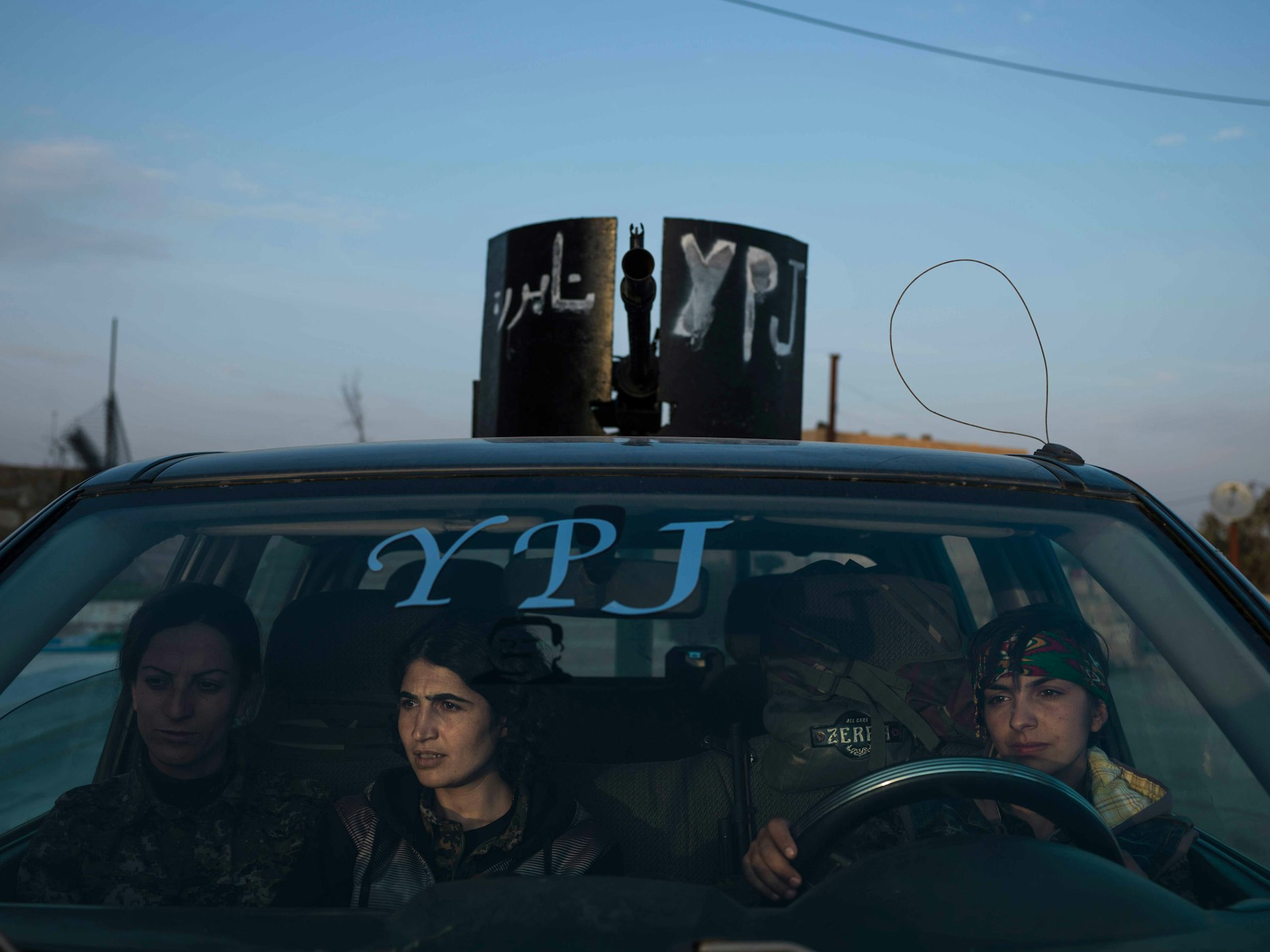 YPJ members sitting in an armed vehicle in Serikani. © Newsha Tavakolian / Magnum Photos