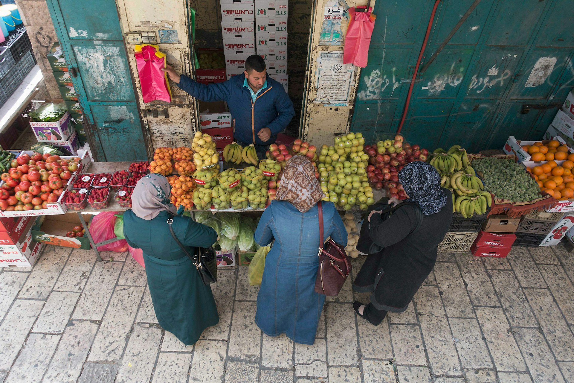Women shop for fruit next to Jaffa Gate in the Old City Jerusalem