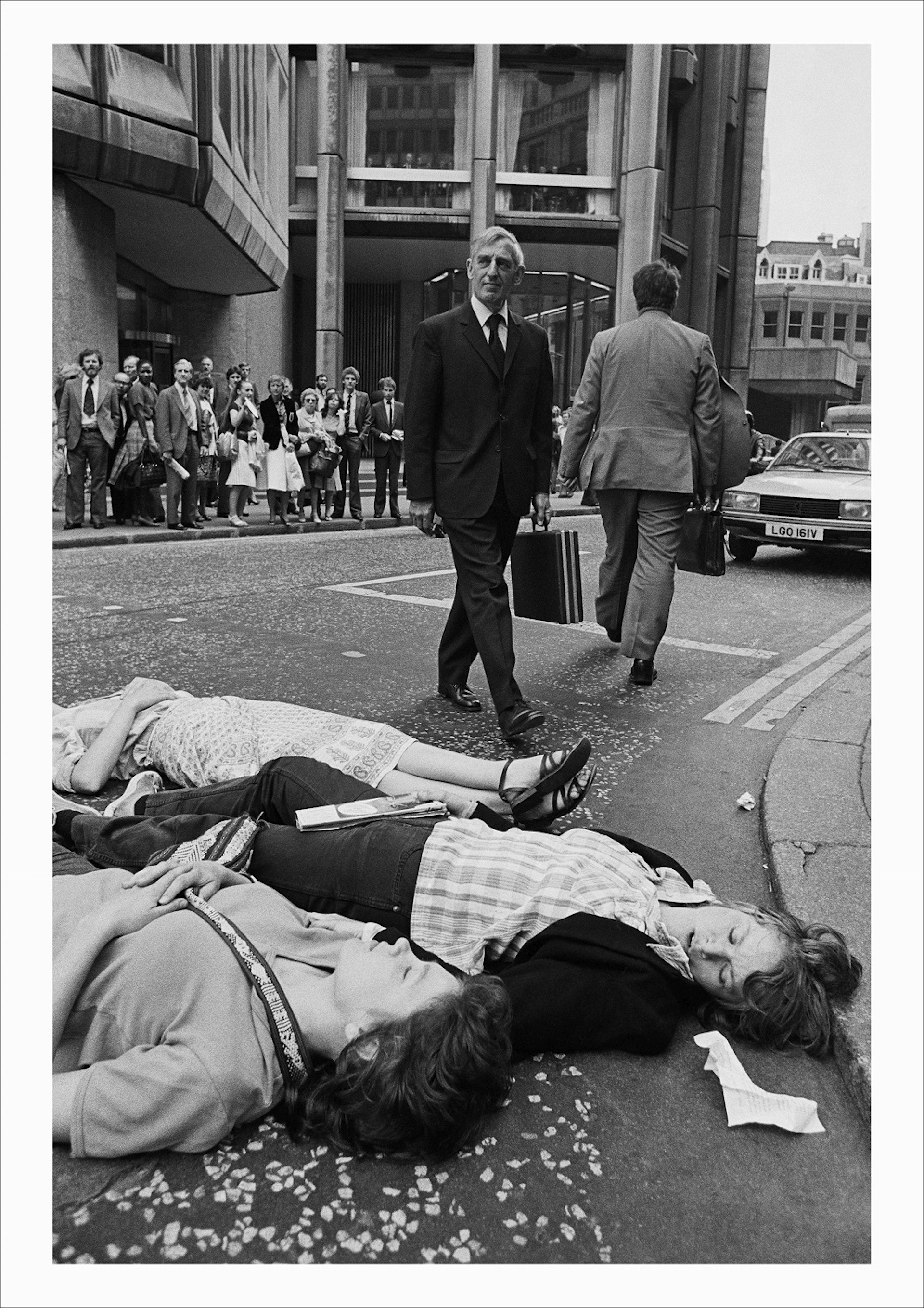 Greenham Common protesters stage a Die-in outside the Stock Exchange during the morning rush hour as U.S President Reagan arrives in Britain, City of London, 1982