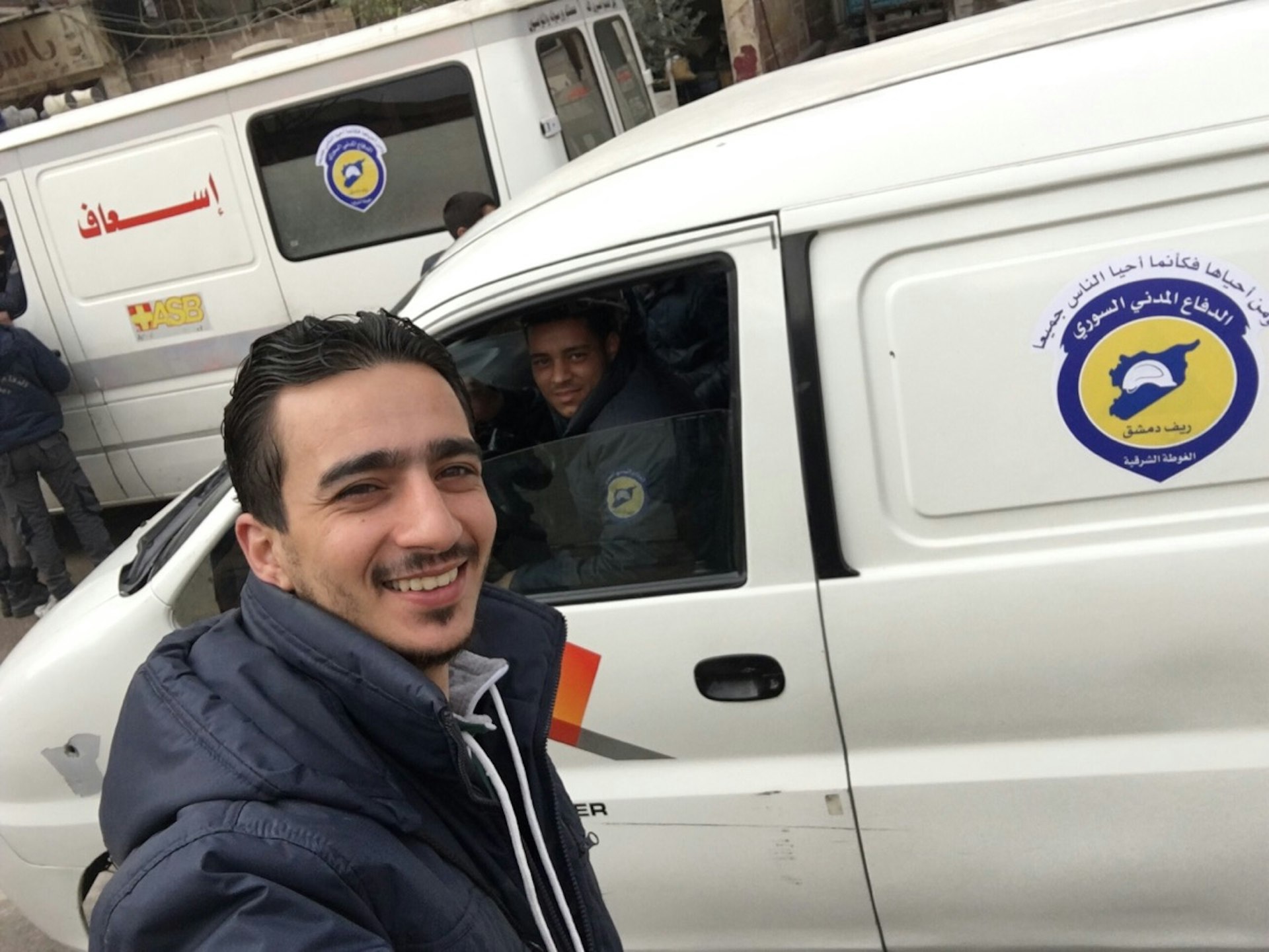 Mahmood in front of a Syrian Civil Defence vehicle