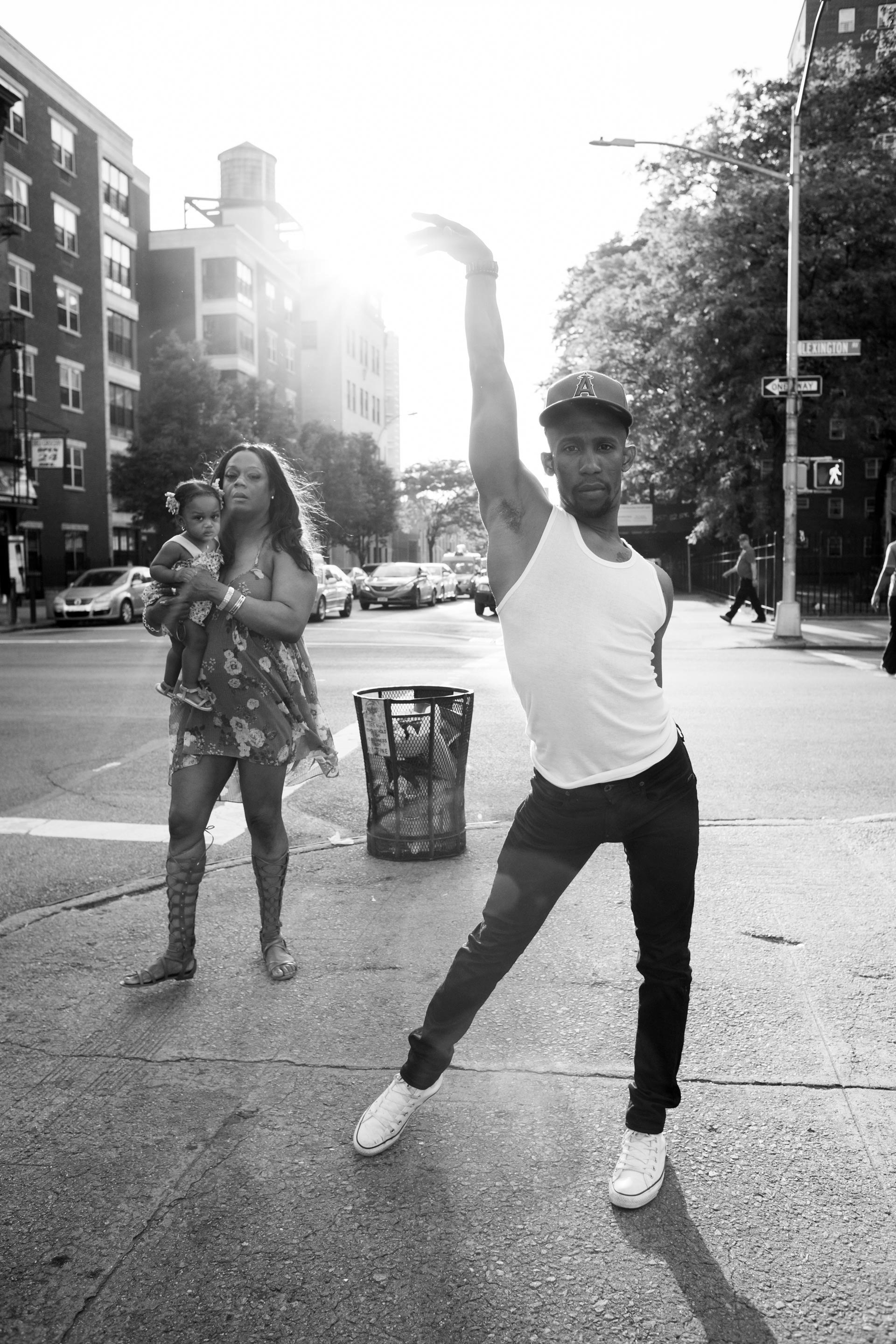 Derek Auguste strikes a vogue pose on Lexington Avenue in East Harlem, NY.