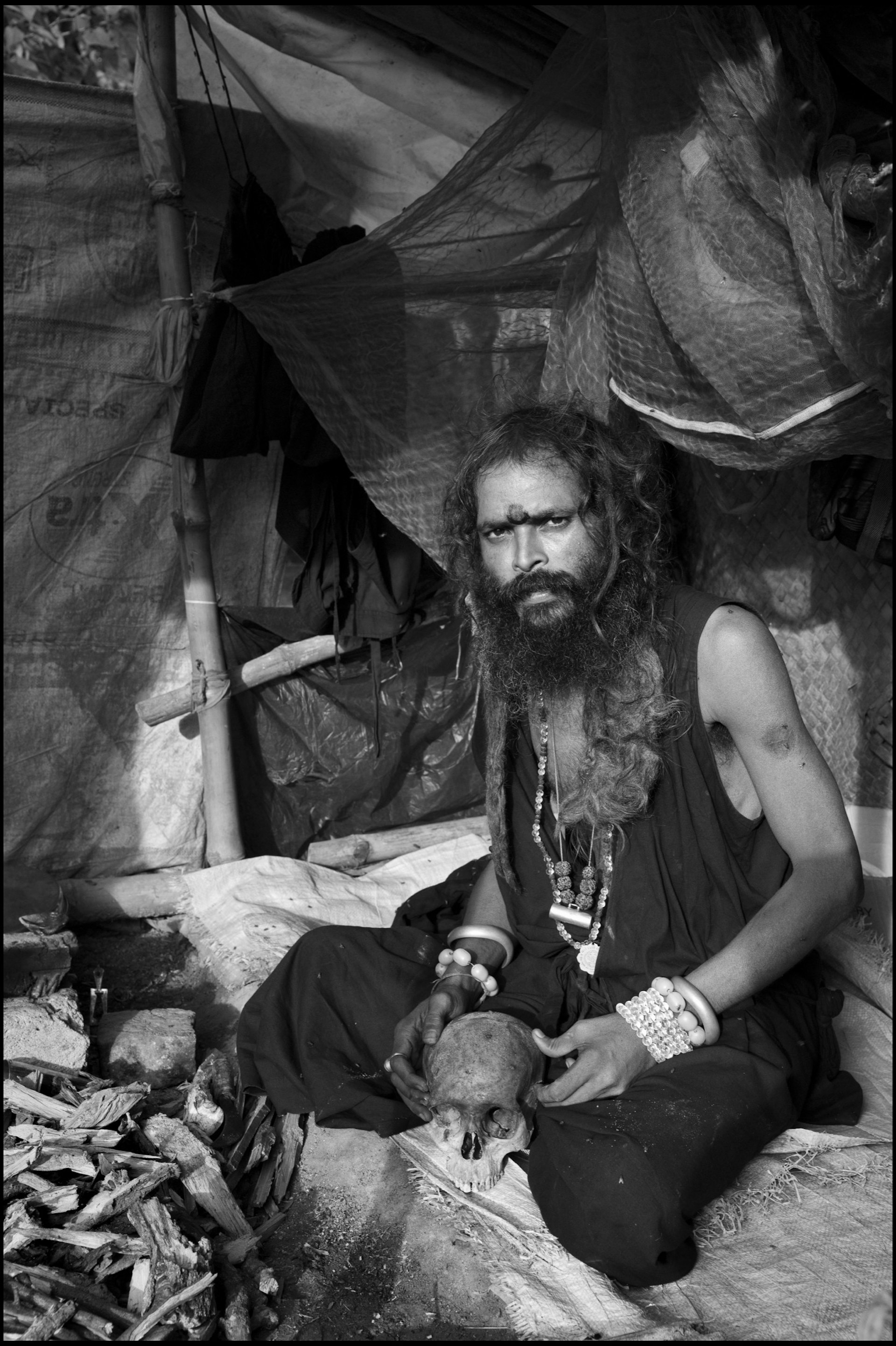 In the grounds of the Bamakhepa burning ghat, a Tantric sannyasi uses the skull of his dead guru ‘to enhance his spiritual powers’ during meditation; Tarapith, India. 