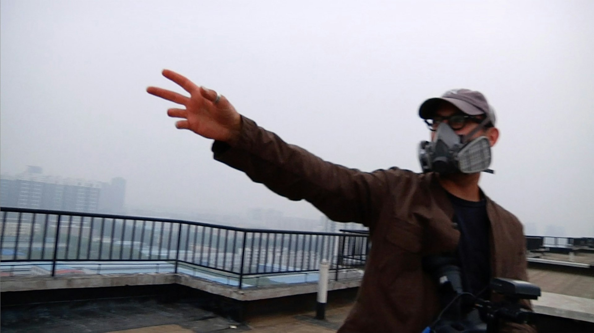 Josh Fox gestures to the oppressive smog from a rooftop in Beijing.