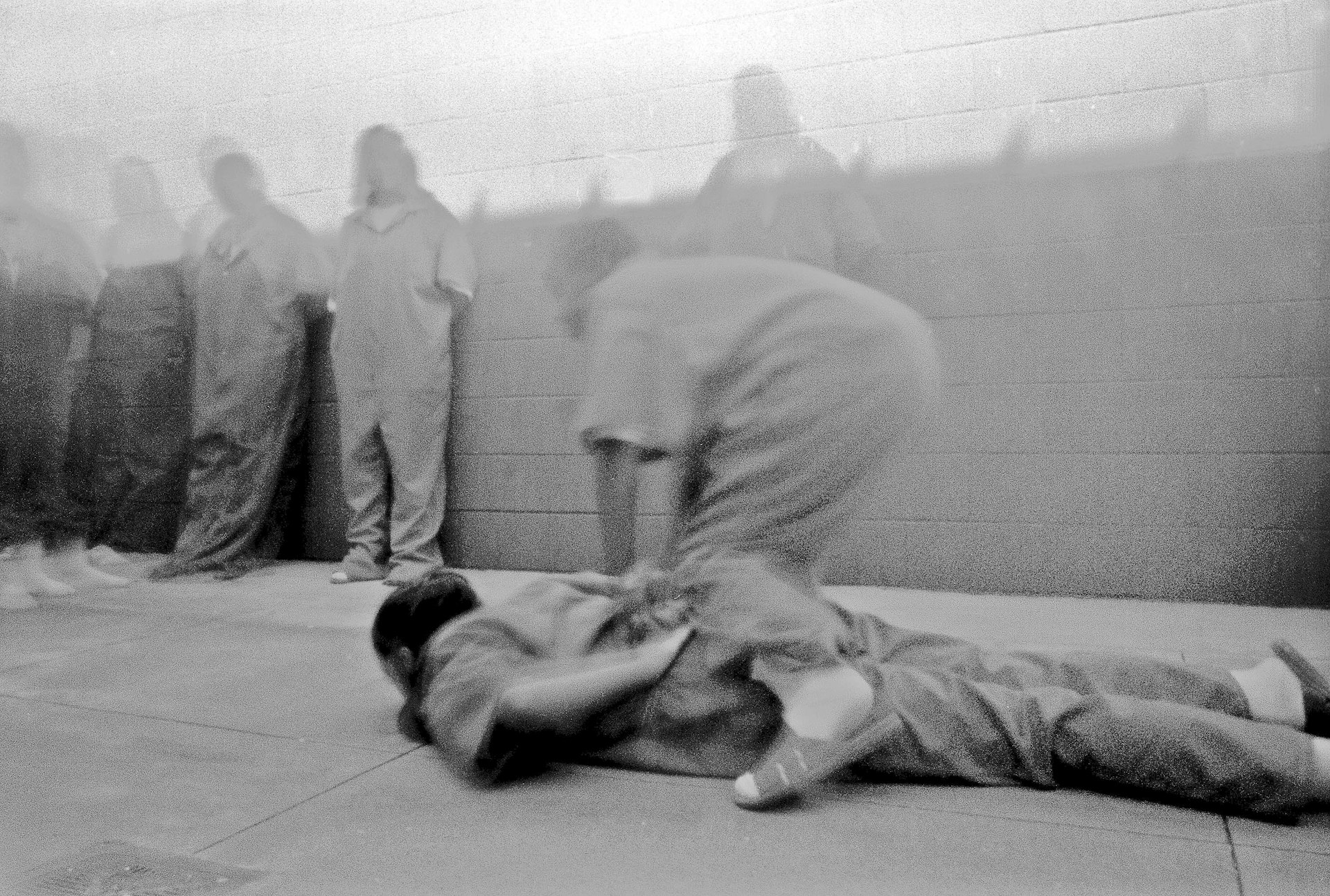 Incarcerated girls at Remann Hall, Tacoma, Washington, reenact restraint techniques in a pinhole camera workshop, 2002. Photo: Anonymous, courtesy of Steve Davis.