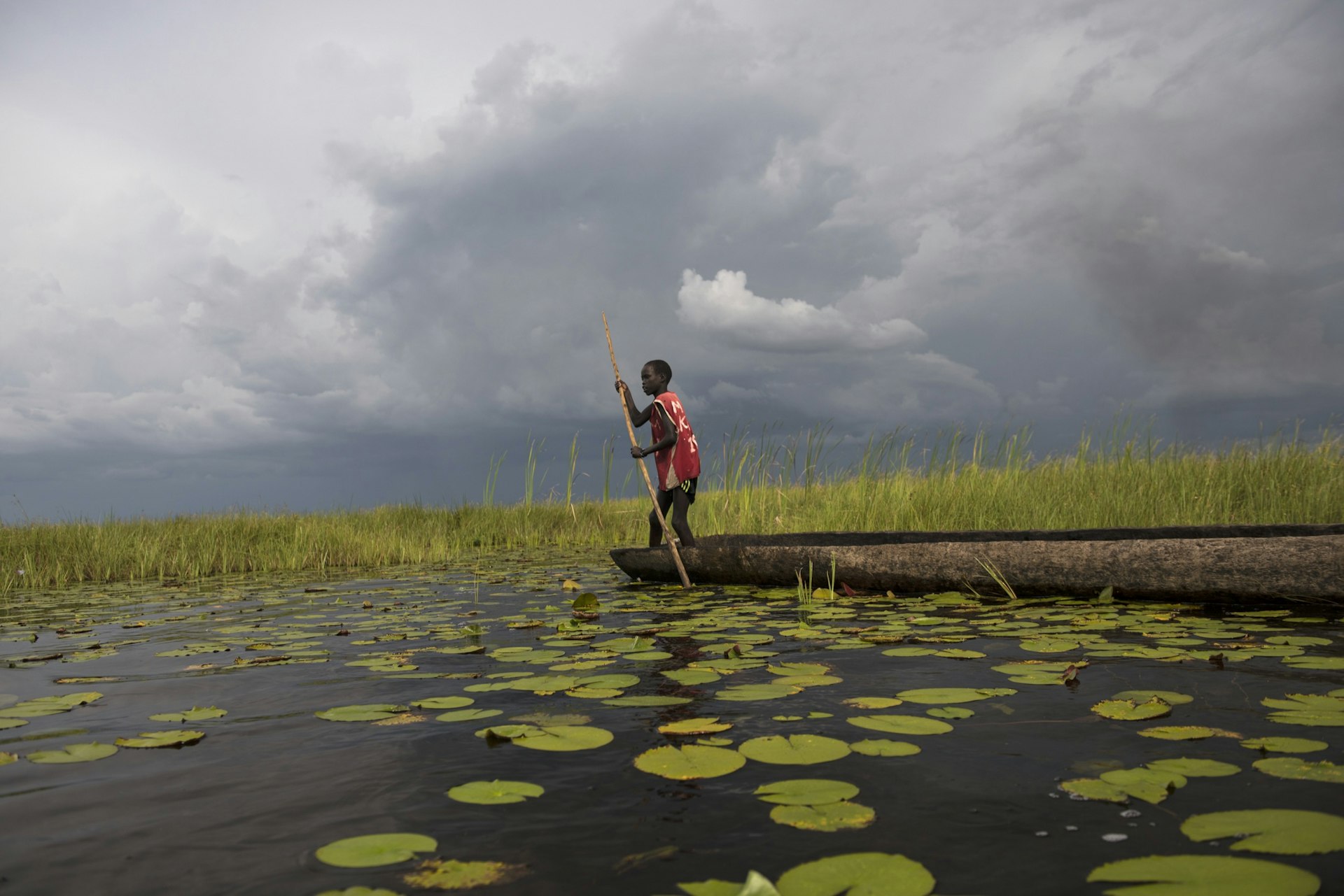 Nine-year-old Chuol fishes for tilapia in a vast swamp in South Sudan after fighters swept into his village, September 2015. 
