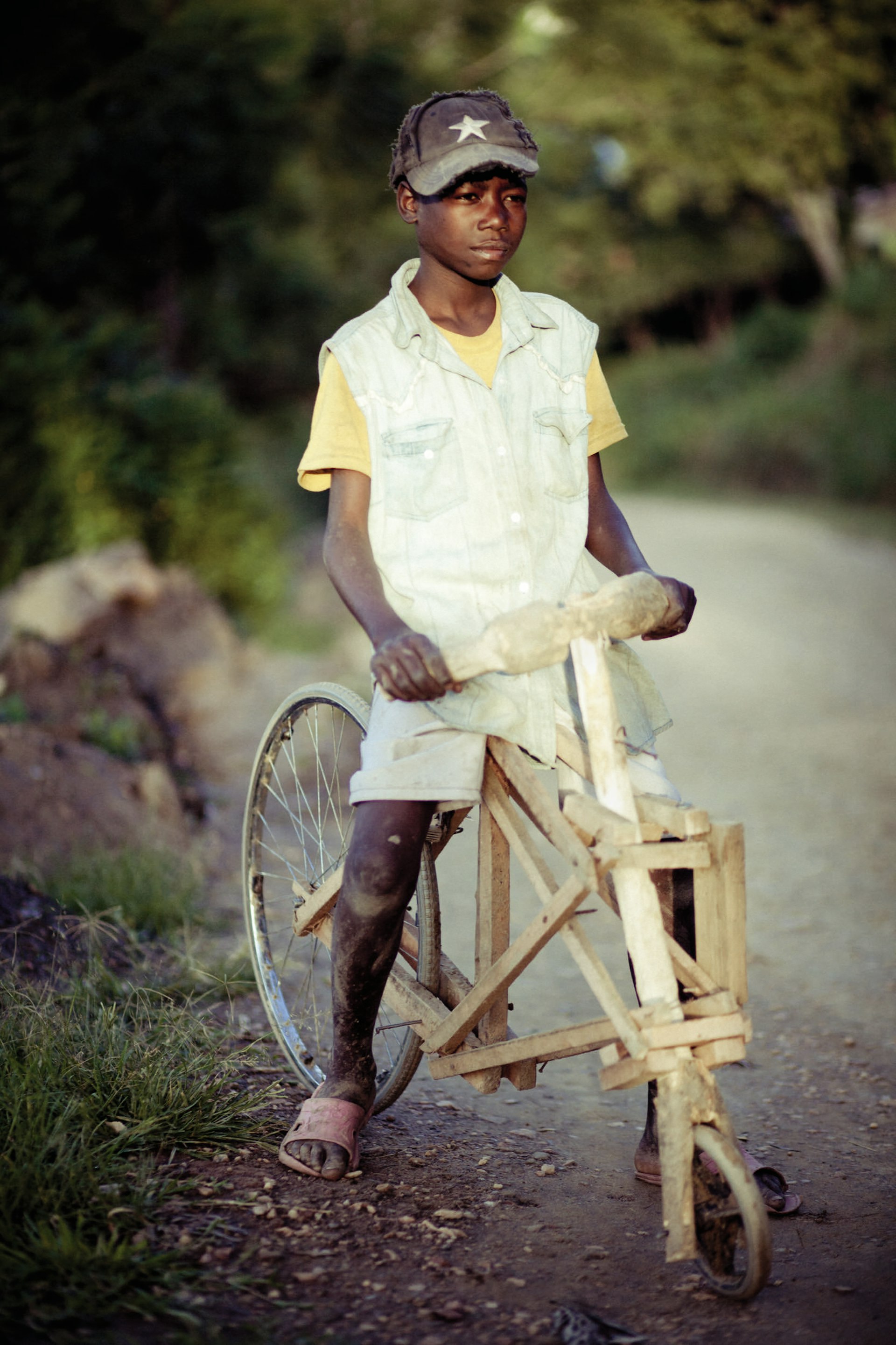 Rukundo Theogen, aged 12, who's home-made wooden bike was one month old