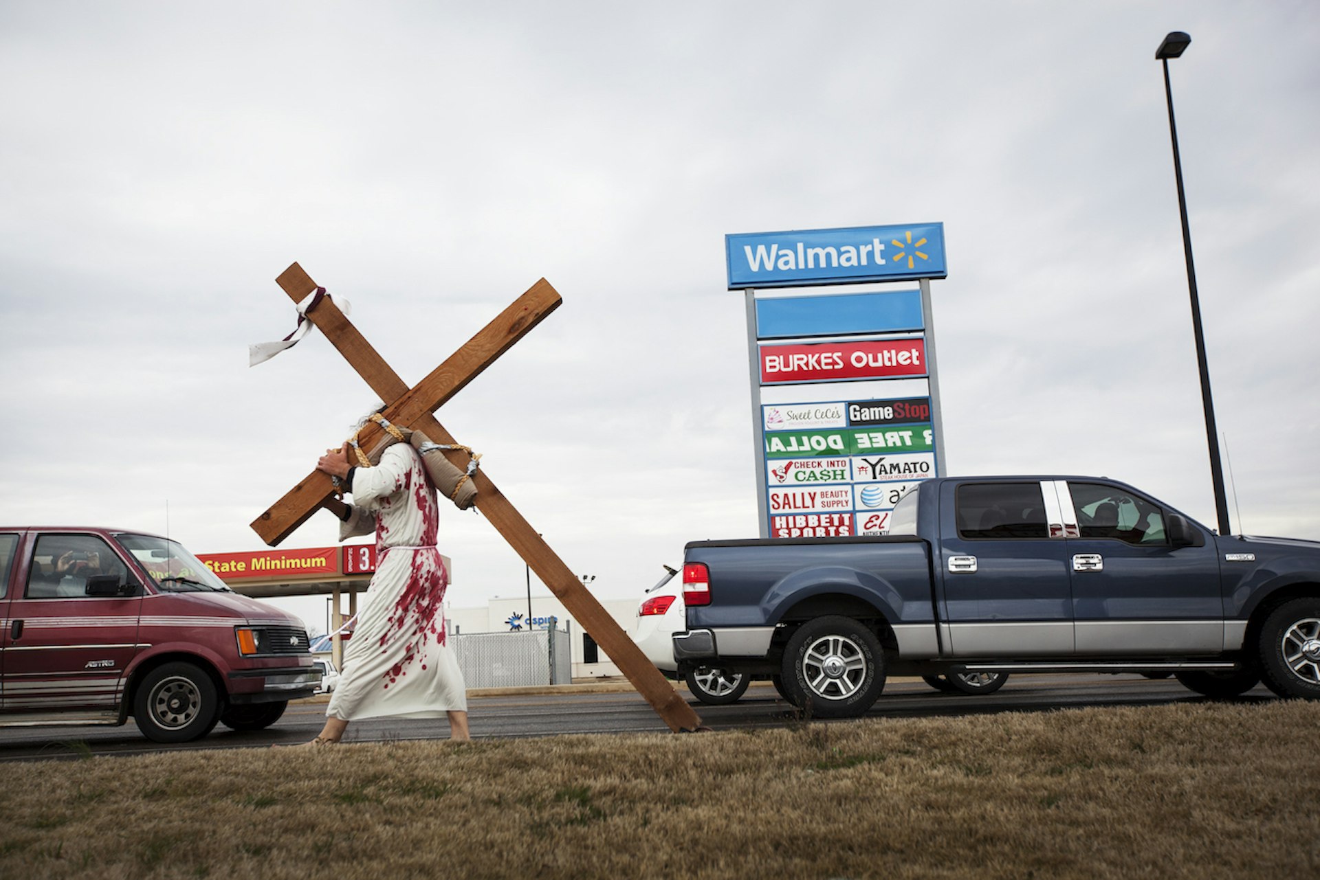 A member of Emmanuel Baptist Church carries the cross around town to remind locals of Jesus' sacrifice on Good Friday.