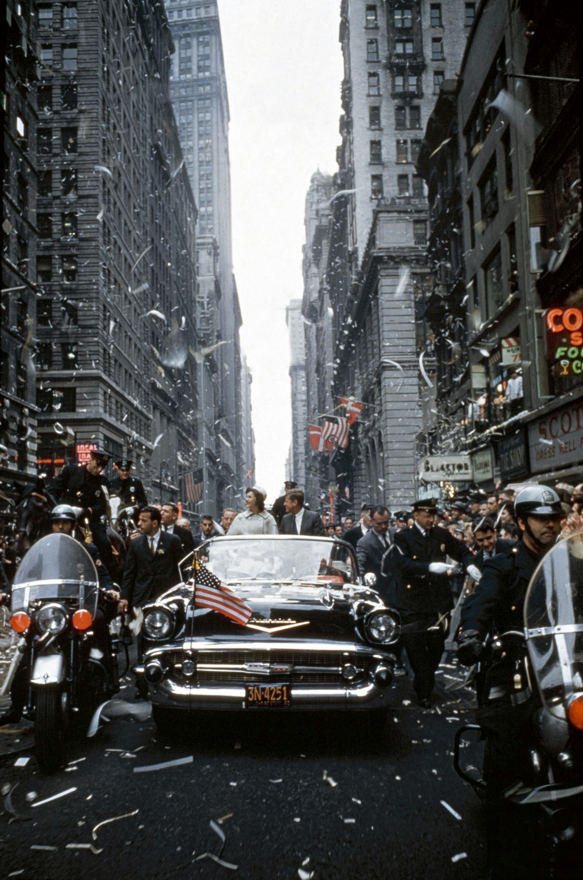 USA. New York City. 1960. Senator John F. KENNEDY and Jacqueline KENNEDY campaign during a ticker tape parade in Manhattan. Photo by Cornell Capa © International Center of Photography.