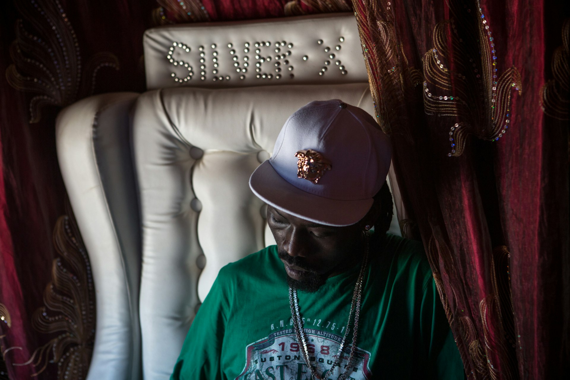 Singer Okuta Ceasar Malis, known as 'Silver X', in his custom-made armchair and imported convertible in Juba.