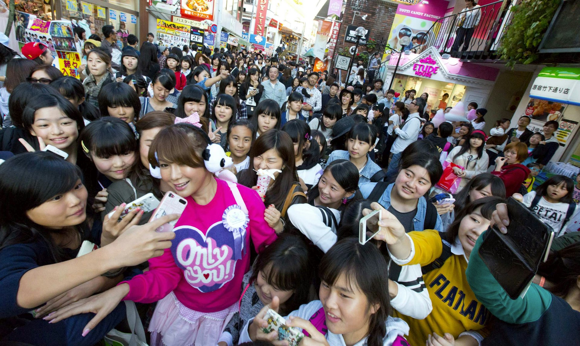 Ai Haruna surrounded by fans in Harajuku, a street popular with teenagers in Tokyo.