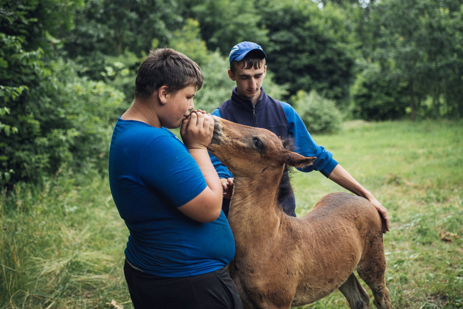  Maxim and Vasya embrace a newborn foal as it stands for the  rst time. In Rotar village, horses are considered key to country living – not just for farm work but as a means of transportation.