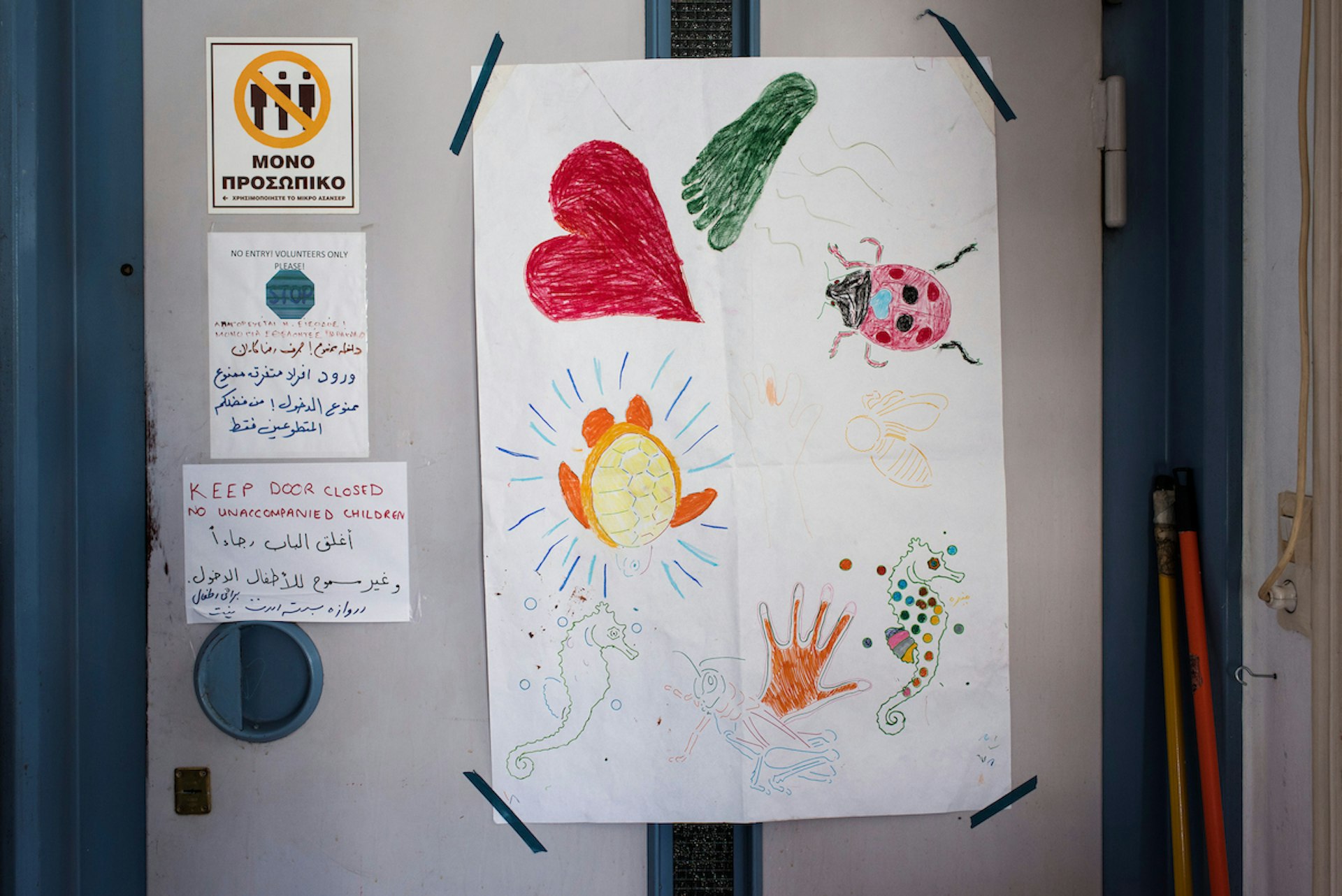 Kids drawings on the lift door at Khora, refugee centre in Athens.