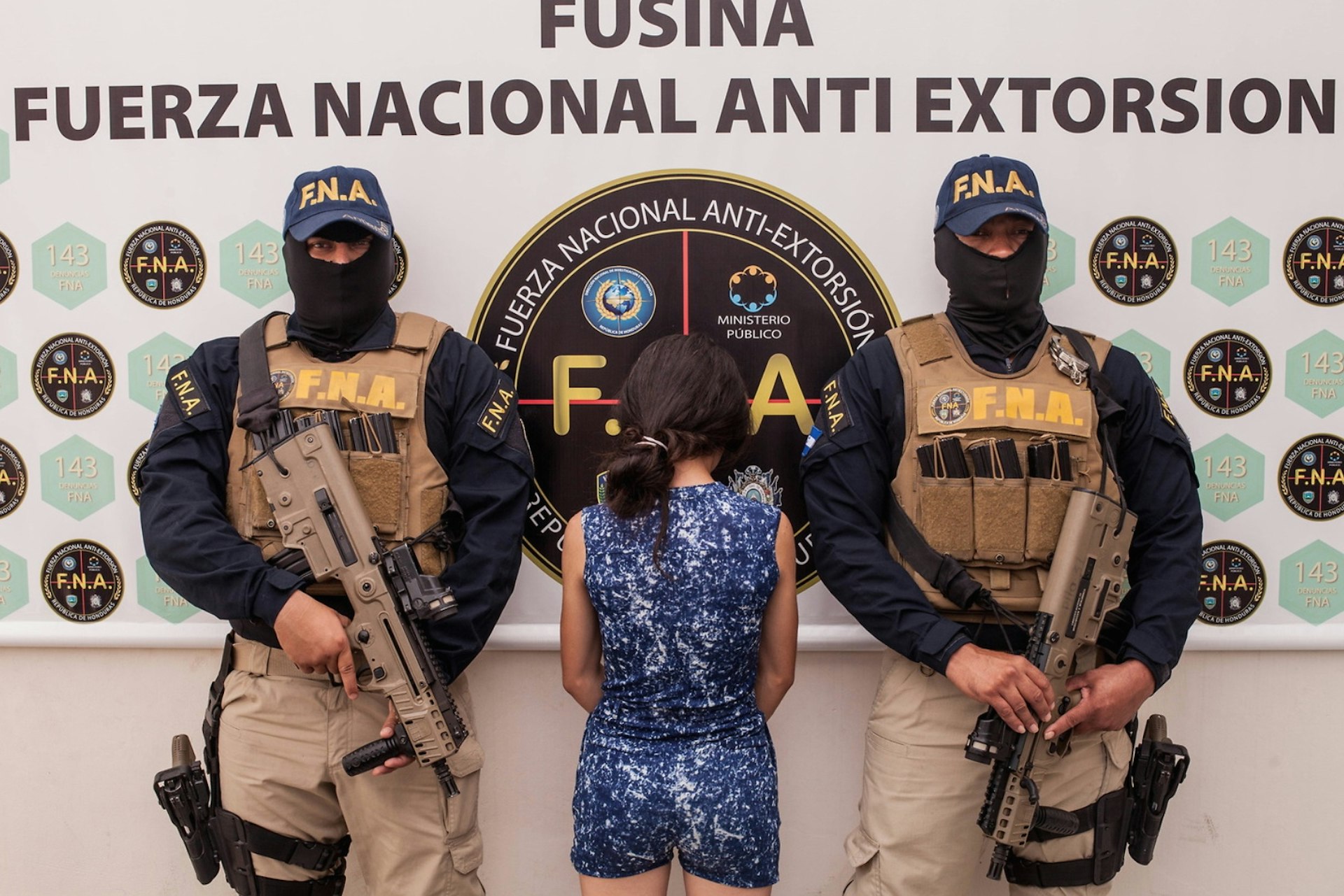 A 16-year-old girl, arrested for extortion, is presented to the press by the police in Tegucigalpa. Teenagers in Honduras are often used to carry out extortion for gangs, their family's lives are threatened if they do not cooperate. If they are caught, like this girl, they will go to prison for taking part in the crime. 9th August 2017.