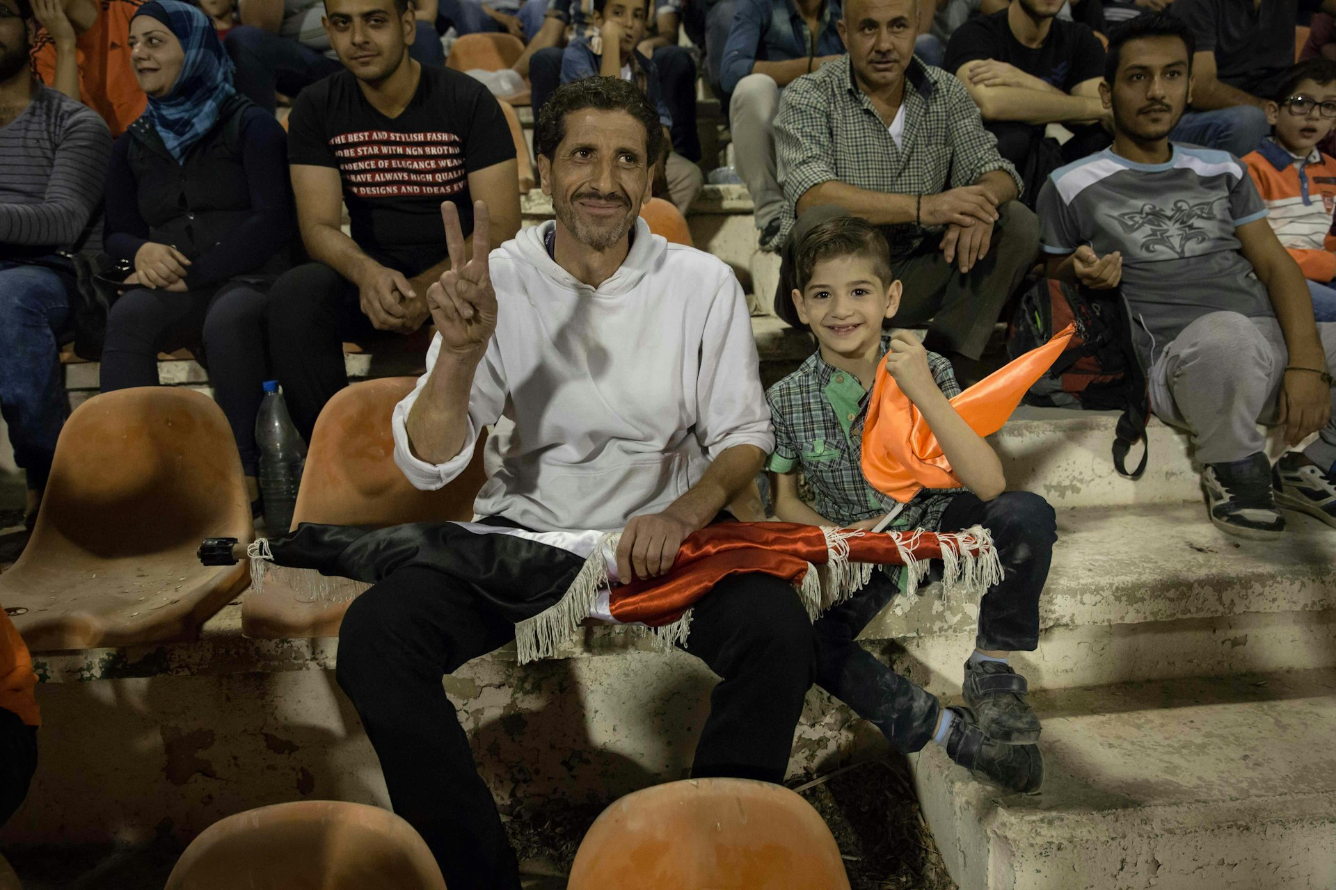 A father and son watch the match from the stands. Many parents said they are still too afraid to bring their children to games.