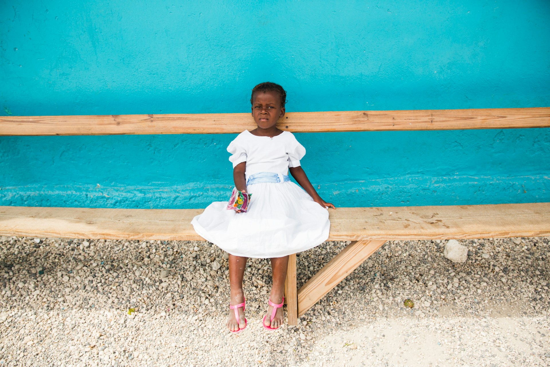 Young girl taking a break during an Easter egg hunt in Despinos, Haiti. She lives in an orphanage in Despinos, Haiti that is run by “Imagine Missions”, which houses, feeds, educates over 100 children.