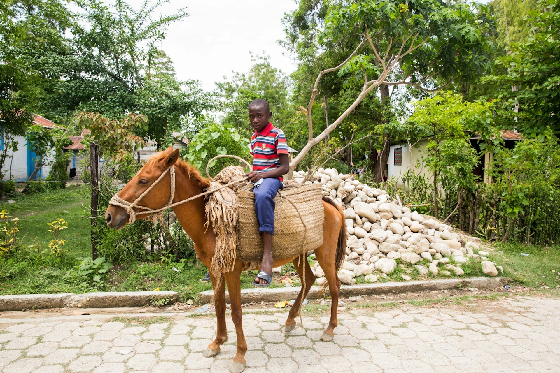 A young farmer on his horse in Central Plateau. Central Plateau is one of the poorest areas of Haiti. It borders the Dominican and most of this land is rural and off the grid.