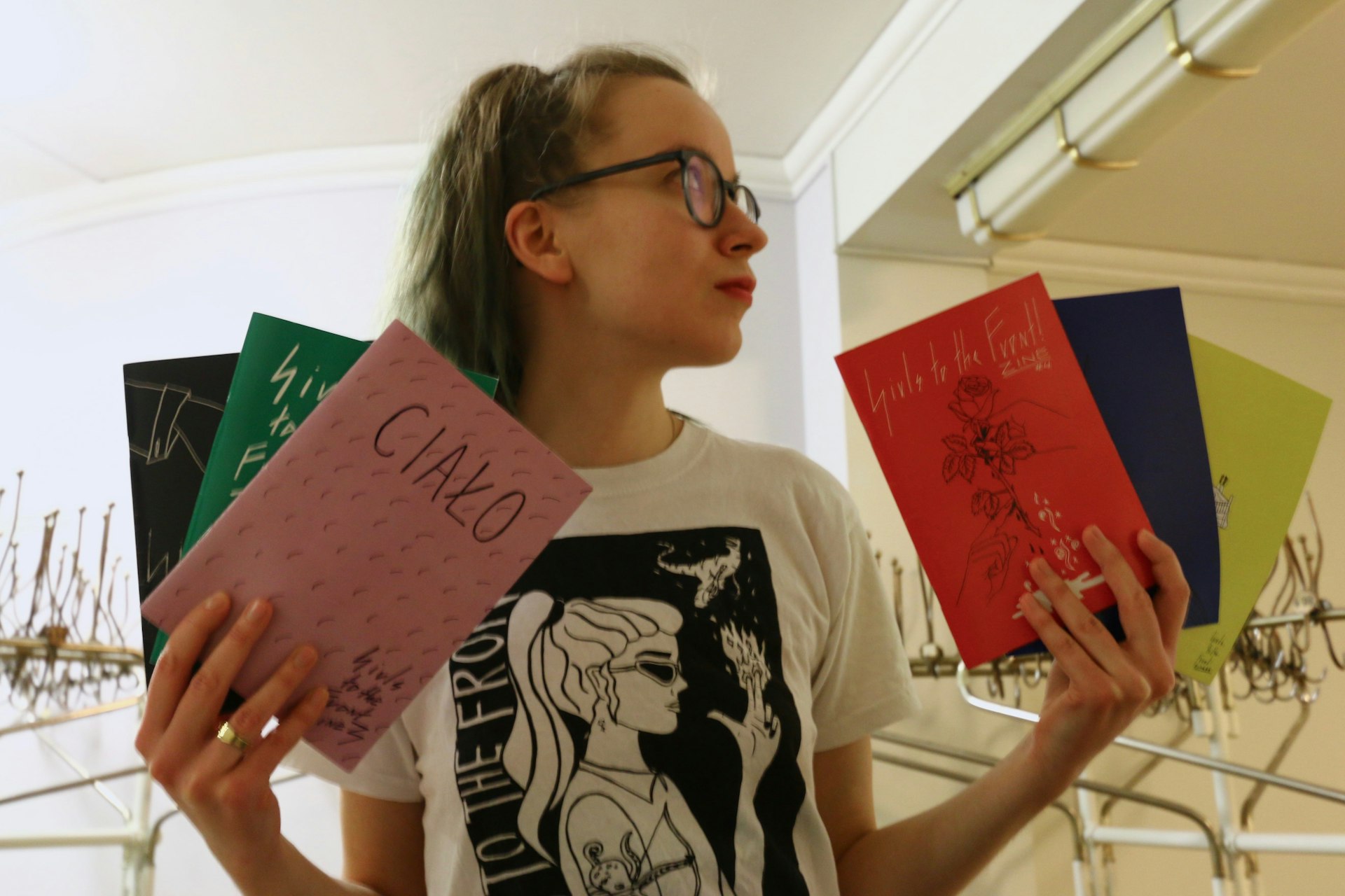 Ola Kamińska with the zine issues of Girls to the Front.