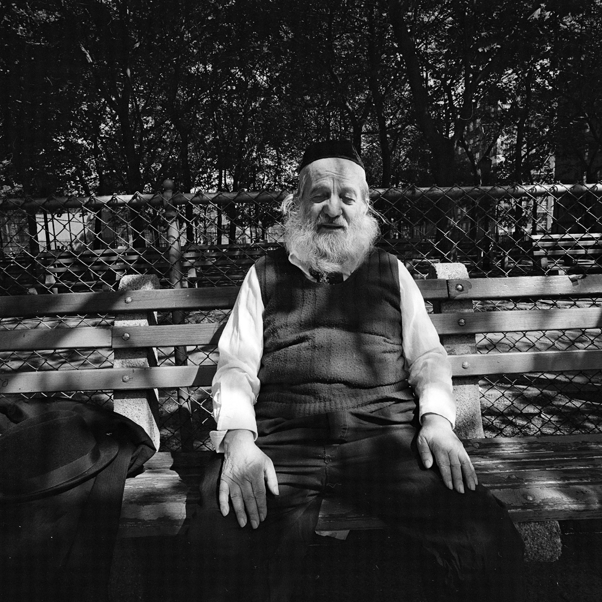 White bearded man on park bench in dappled sunlight NY, NY May 1977