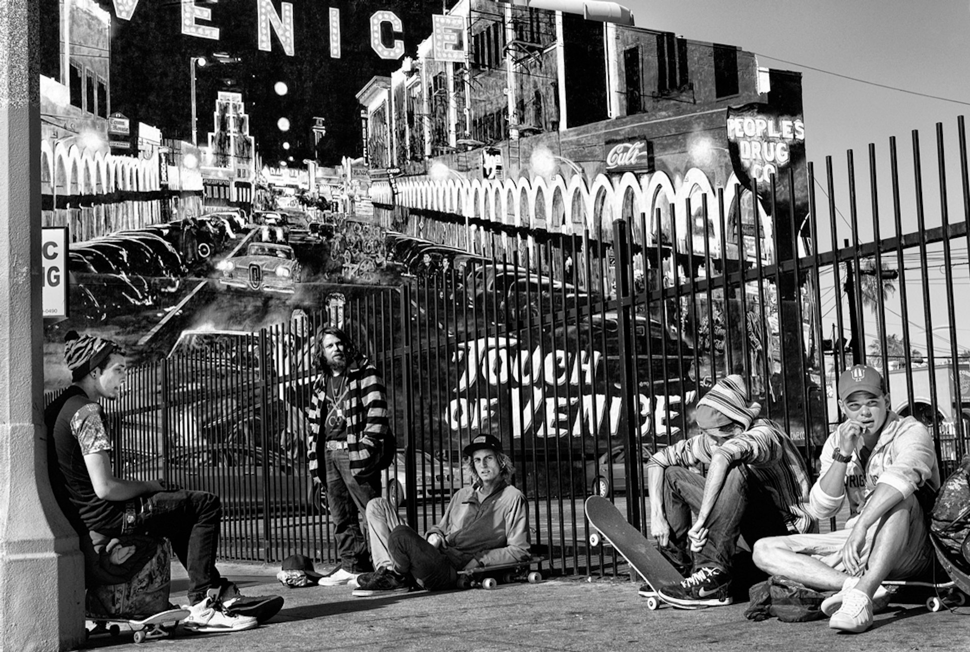 A group of young skateboarders gather to smoke marijuana in the early morning sun in front of the iconic Touch of Venice mural on Wind- ward Avenue.© Dotan Saguy