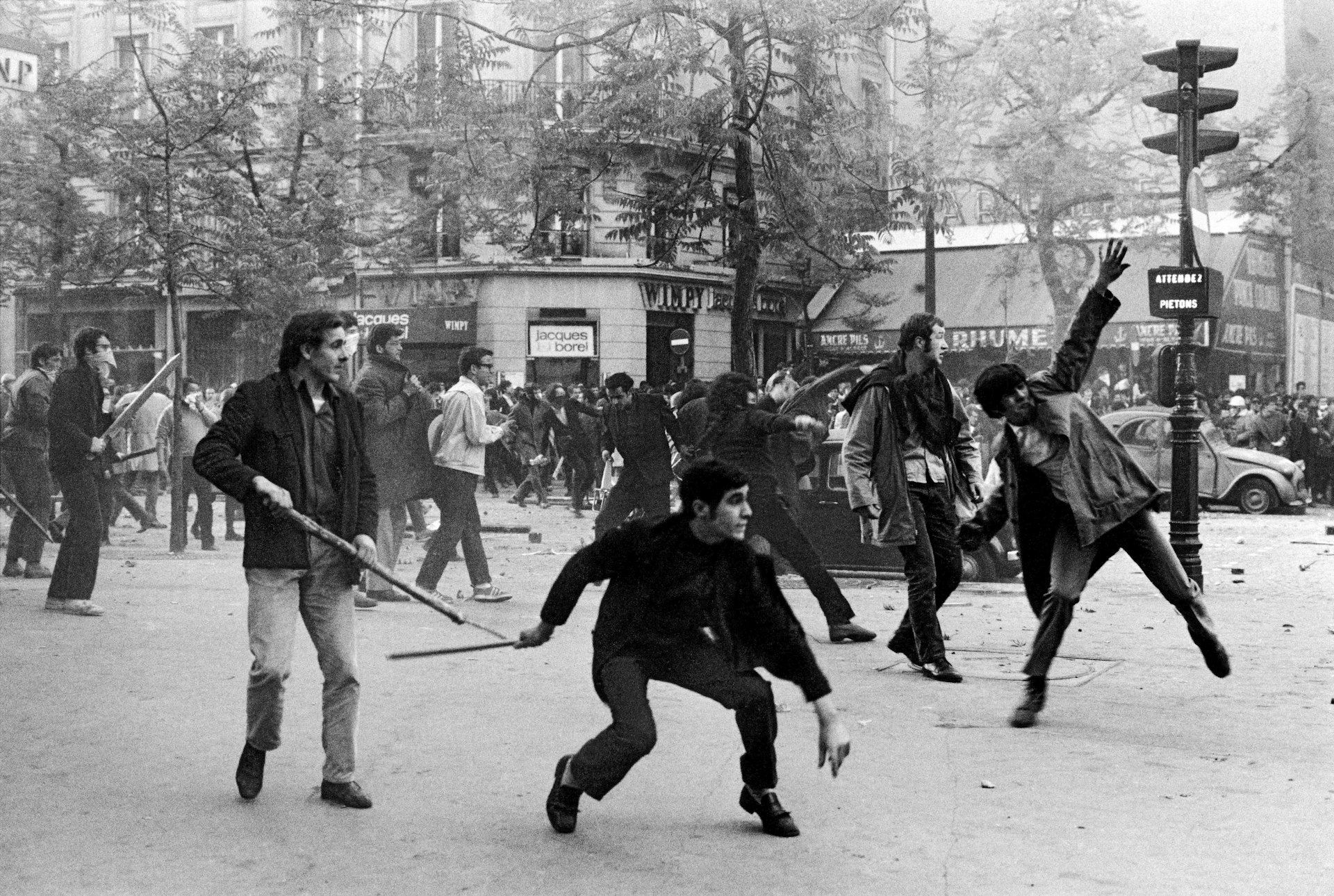 Students hurling objects at the police. Boulevard Saint-Germain, 6th arrondissement, Paris, France. May 6, 1968. © Bruno Barbey / Magnum Photos