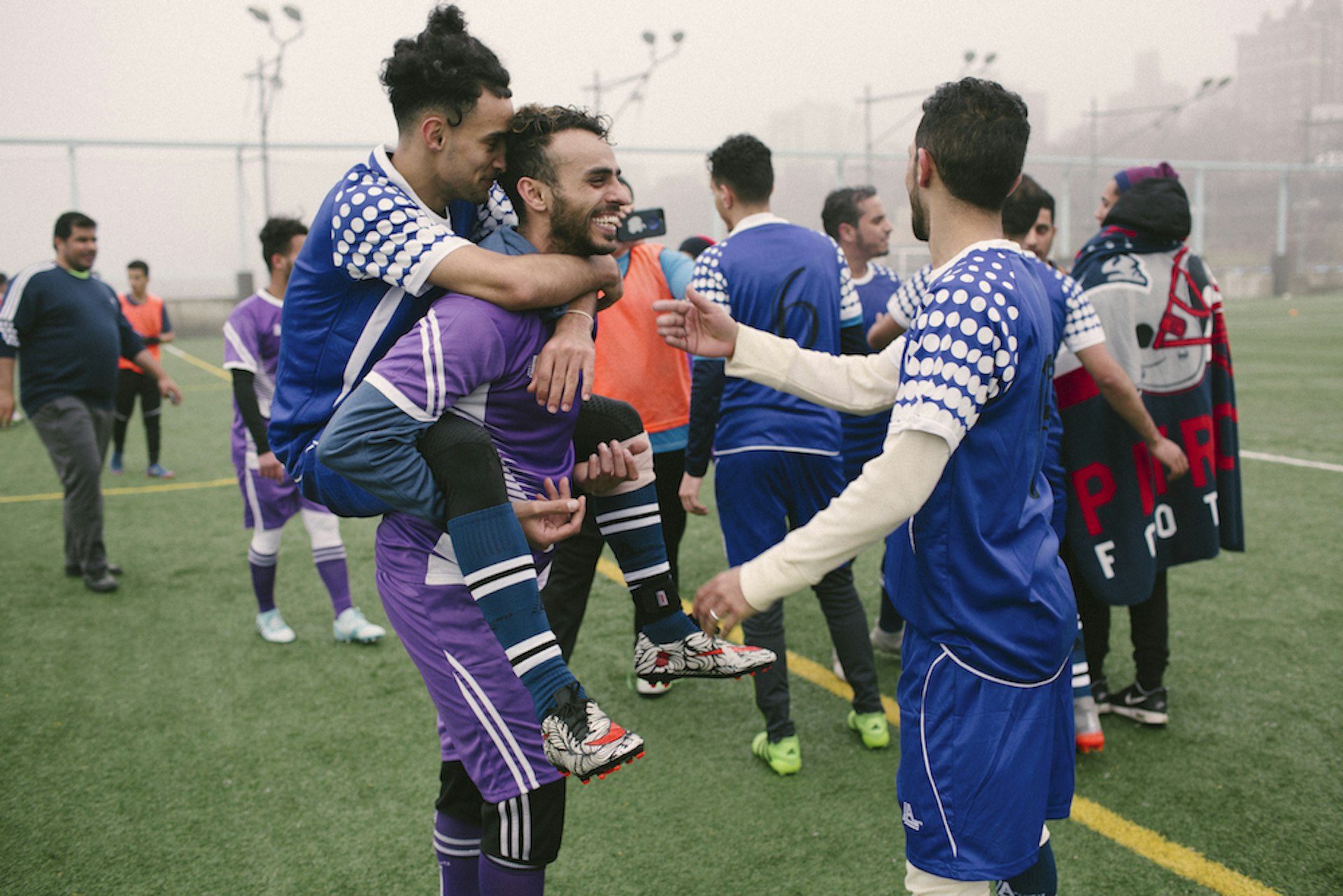 Yosef Aymar and Ahmed Elsamet joke around with their teammates after a training session.