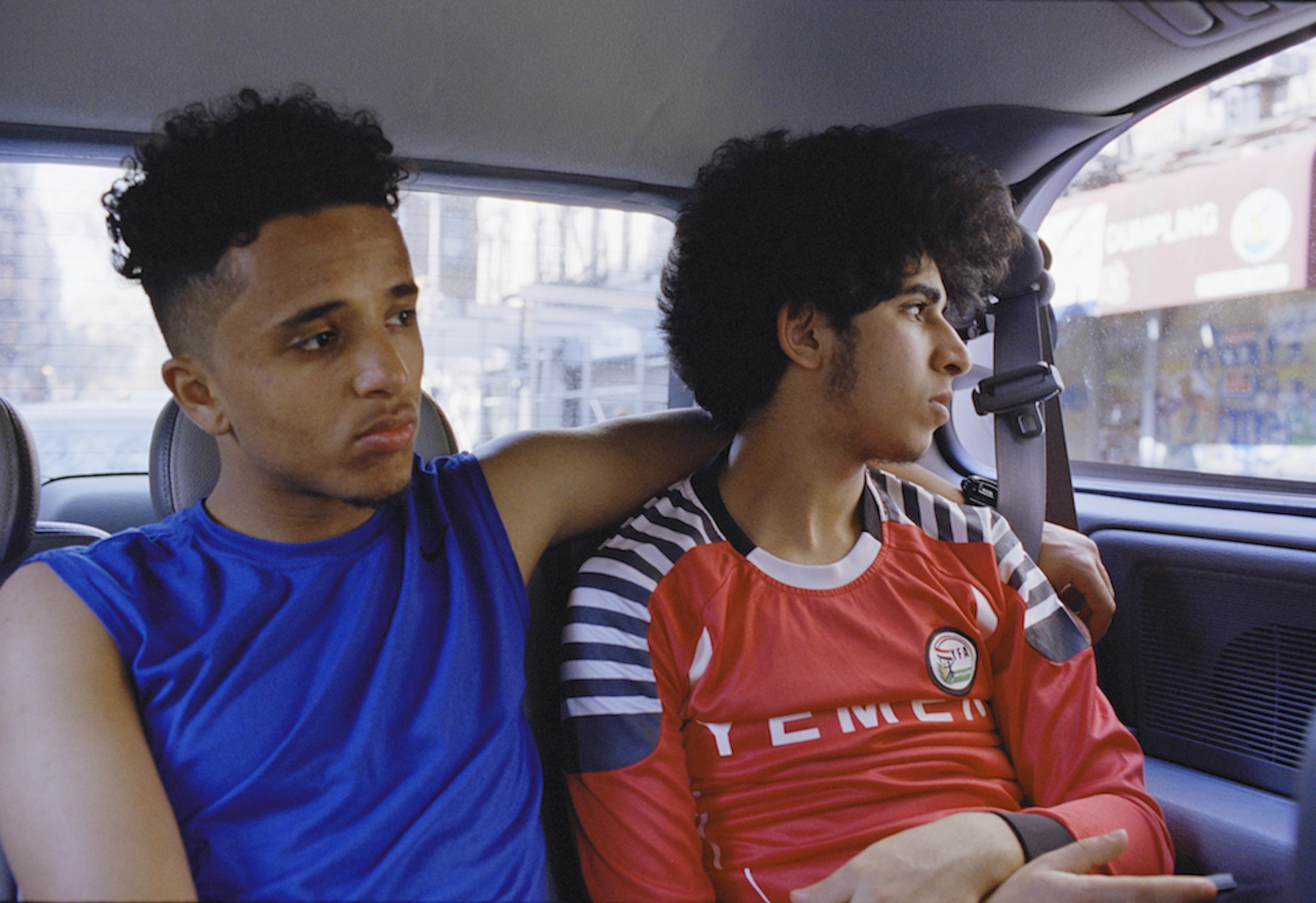 Ahmed Alzandhani and Osama Alsahybi ride in the back of Heidara Nasser's van after an early morning friendly game in the Bronx.