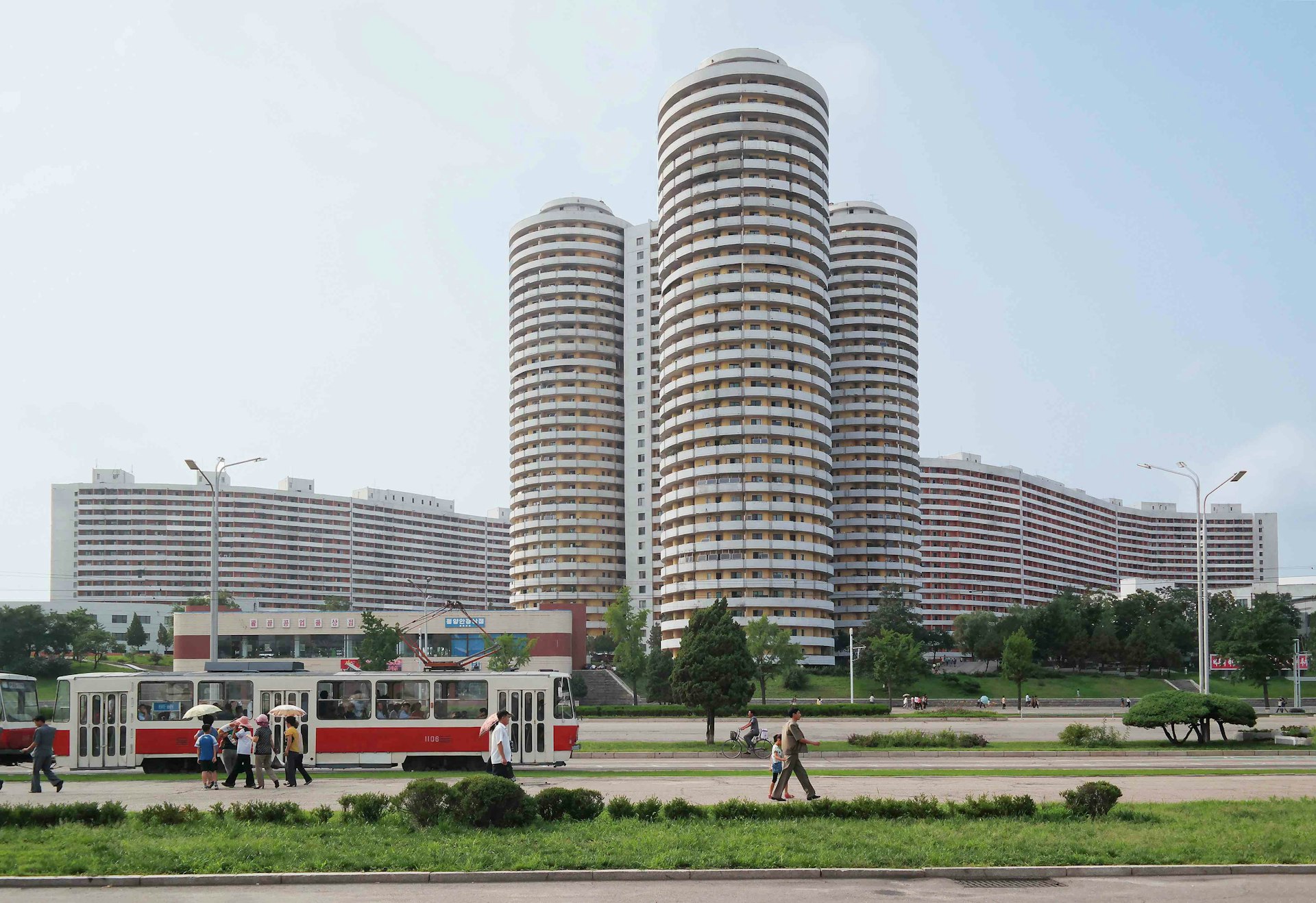 Cylindrical apartment towers for the Pyongyang elite line down the 4km- long avenue of Kwangbok Street, a ceremonial boulevard built for the 1989 World Festival of Youth and Students. As Kim Jong Il wrote approvingly: “In the formation of Kwangbok Street, a large variety of shapes, such as cylinders, windmills, polygons, the letter S and steps, were adopted for apartment blocks. [...] The arrangement of buildings on straight lines along the main street is an outmoded method.”